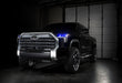 Three quarters view of a black Toyota Tundra with blue demon eye projectors.