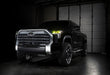 Three quarters view of a black Toyota Tundra with yellow demon eye projectors.