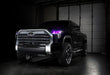 Three quarters view of a black Toyota Tundra with pink demon eye projectors.