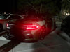 Three quarters view of a Dodge Charger with red headlight DRLs.