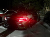 Three quarters view of a Dodge Charger with red headlight DRLs.