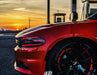 Side view of the front end of a Dodge Charger with red headlight DRLs.