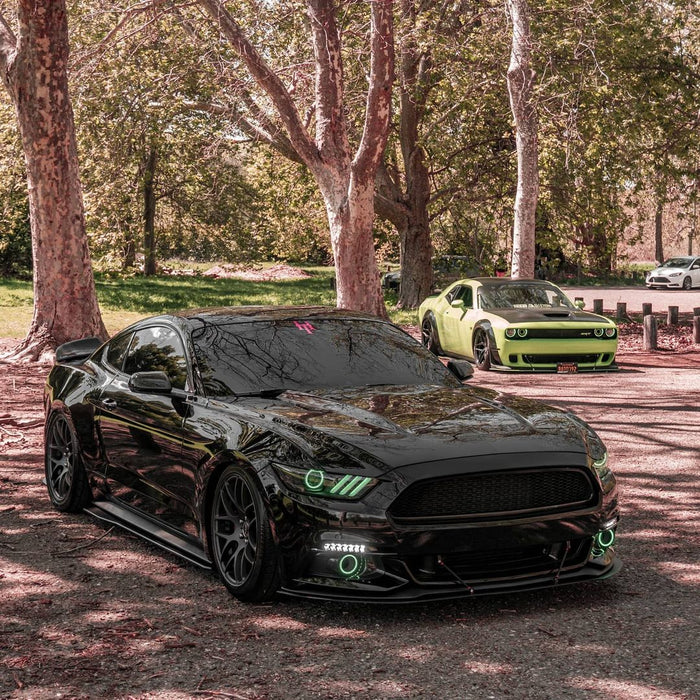 Three quarters view of a Ford Mustang with green headlight halos and DRLs installed.