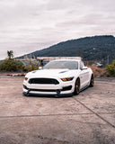 Three quarters view of a Ford Mustang with amber headlight halos and DRLs.