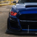 Front end of a Ford Mustang with red headlight halos and DRLs.
