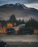 Three quarters view of a Ford Mustang with amber headlight halos and DRLs.