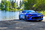 Three quarters view of a blue Chevrolet Camaro with red headlight and fog light DRLs.