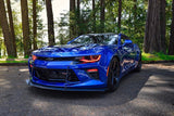 Three quarters view of a Chevrolet Camaro with red headlight and fog light DRLs.