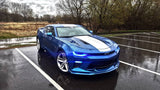 Three quarters view of a Chevrolet Camaro with blue headlight and fog light DRLs.