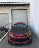 Front view of a Chevrolet Camaro with green headlight and fog light DRLs.