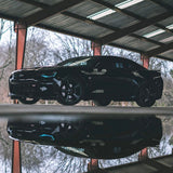 Black Camaro with cyan DRLs.