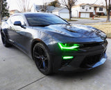 Three quarters view of a black Chevrolet Camaro with green headlight DRLs.