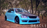 Three quarters view of a Lexus IS300 with white LED headlight halo rings installed.