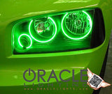 Close-up of charger headlight with green halos.