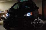 Smart Car with white LED headlight halo rings installed.