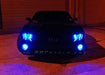 Front end of a Chevrolet Camaro with blue LED headlight and fog light halo rings installed.
