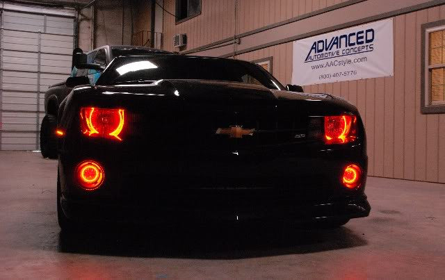 Front end of a Chevrolet Camaro with red LED headlight and fog light halo rings installed.