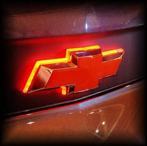 Close-up of Illuminated LED Rear Bowtie Emblem installed on a Chevrolet Camaro.