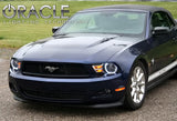 Front end of a Ford Mustang with white LED headlight halo rings installed.