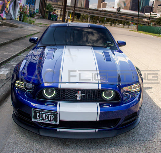 Front end of a Ford Mustang with white LED fog light halo rings installed.