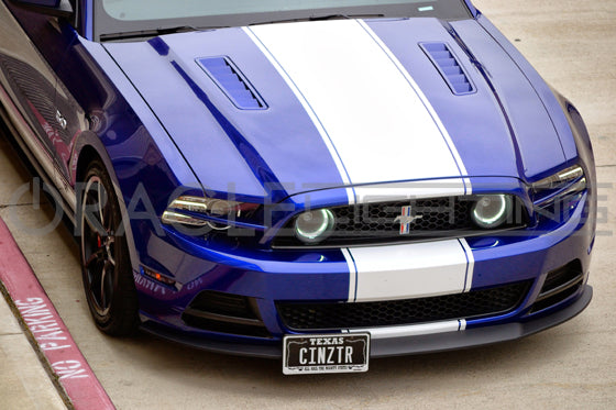 Front end of a Ford Mustang with white LED fog light halo rings.