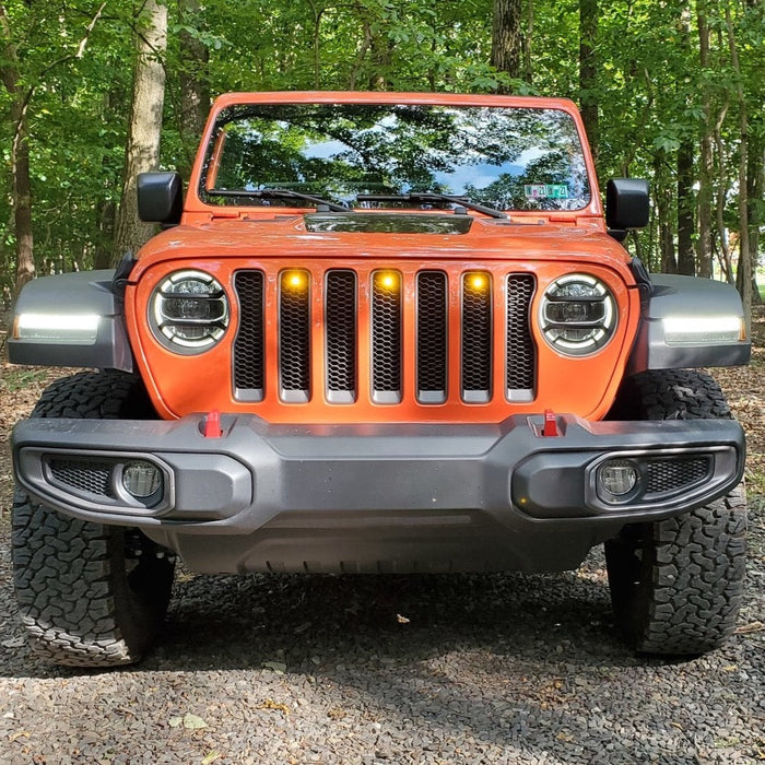 Front end of a Jeep Wrangler JL with amber Pre-Runner Style LED Grill Light Kit installed.
