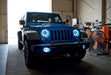 Three quarters view of a Jeep Wrangler with white LED headlight and fog light halos installed.