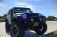 Three quarters view of a Jeep Wrangler JK with blue LED headlight halos installed.