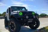 Three quarters view of a Jeep Wrangler JK with green LED headlight halos installed.