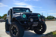 Three quarters view of a Jeep Wrangler JK with cyan LED headlight halos installed.