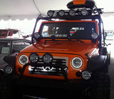 Front end of a Jeep Wrangler JK with white LED headlight halos installed.