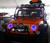 Front end of a Jeep Wrangler JK with purple LED headlight halos installed.