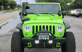 Front end of a Jeep Wrangler JK with white LED headlight and fog light halos installed.