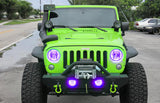 Front end of a Jeep Wrangler JK with purple LED headlight and fog light halos installed.