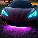 Front end of a C8 Corvette with cyan headlight DRLs.