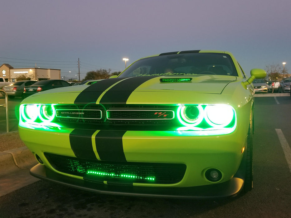 Front end of a Dodge Challenger with green LED headlight halo rings installed.