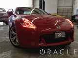 Front end of a Nissan 370Z with red LED headlight halo rings installed.