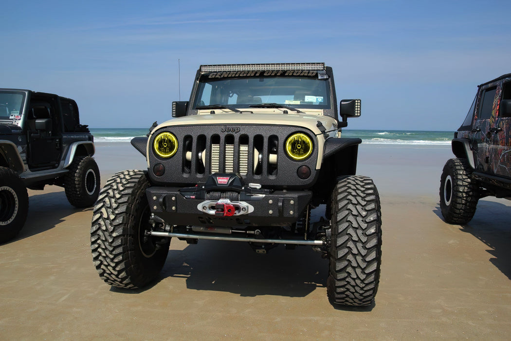 Front end of a Jeep Wrangler JK with yellow LED headlight halos installed.