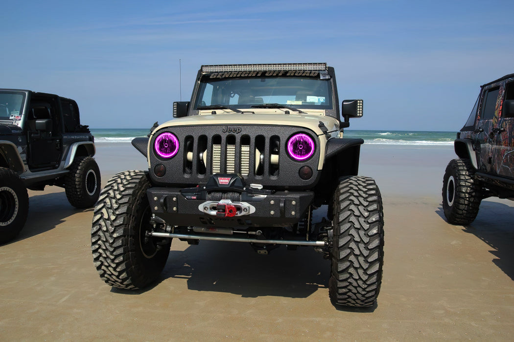 Front end of a Jeep Wrangler JK with pink LED headlight halos installed.
