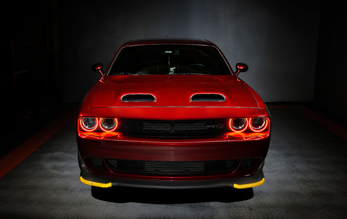 Front view of a red Dodge Challenger with red LED headlight halo rings installed.