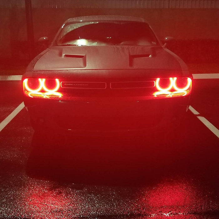 Front end of a Dodge Challenger with red LED headlight halo rings installed.
