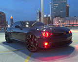 Three quarters view of a Chevrolet Camaro with red LED headlight and fog light halo rings installed.