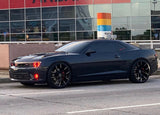 Three quarters view of a Chevrolet Camaro with red LED headlight and fog light halo rings.