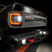 Close-up on the rear end of a Jeep Gladiator with reverse lights on.