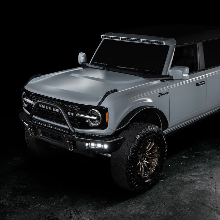 Three quarters view of grey Ford Bronco with Triple LED Fog Lights turned on.