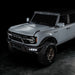 Three quarters view of grey Ford Bronco with Triple LED Fog Lights turned on.