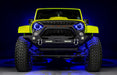 Front view of a yellow Jeep with 7" Oculus Headlights installed, set to blue LEDs.