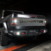 Rear view of a Jeep Gladiator with reverse lights on.