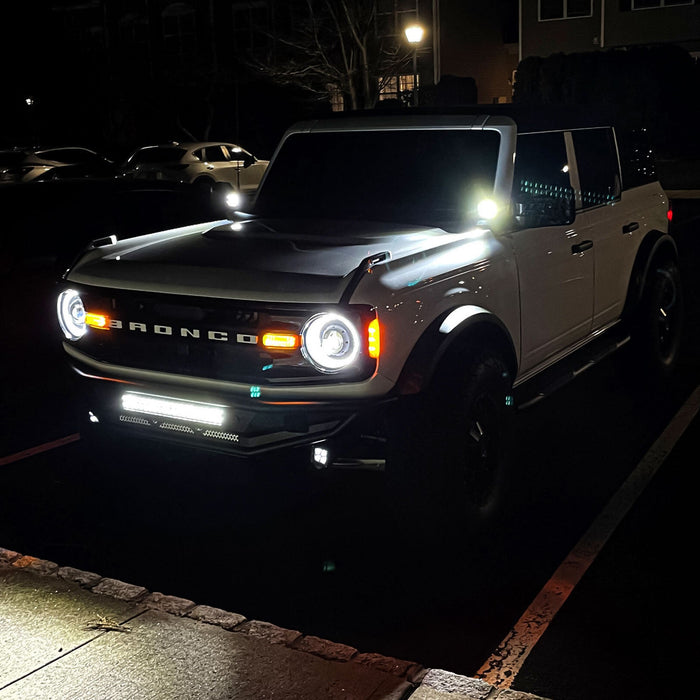 White Ford Bronco with Oculus Headlights installed and turned on.