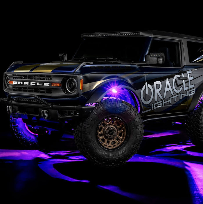 Three quarters view of wrapped Ford Bronco with purple LED rock lights installed